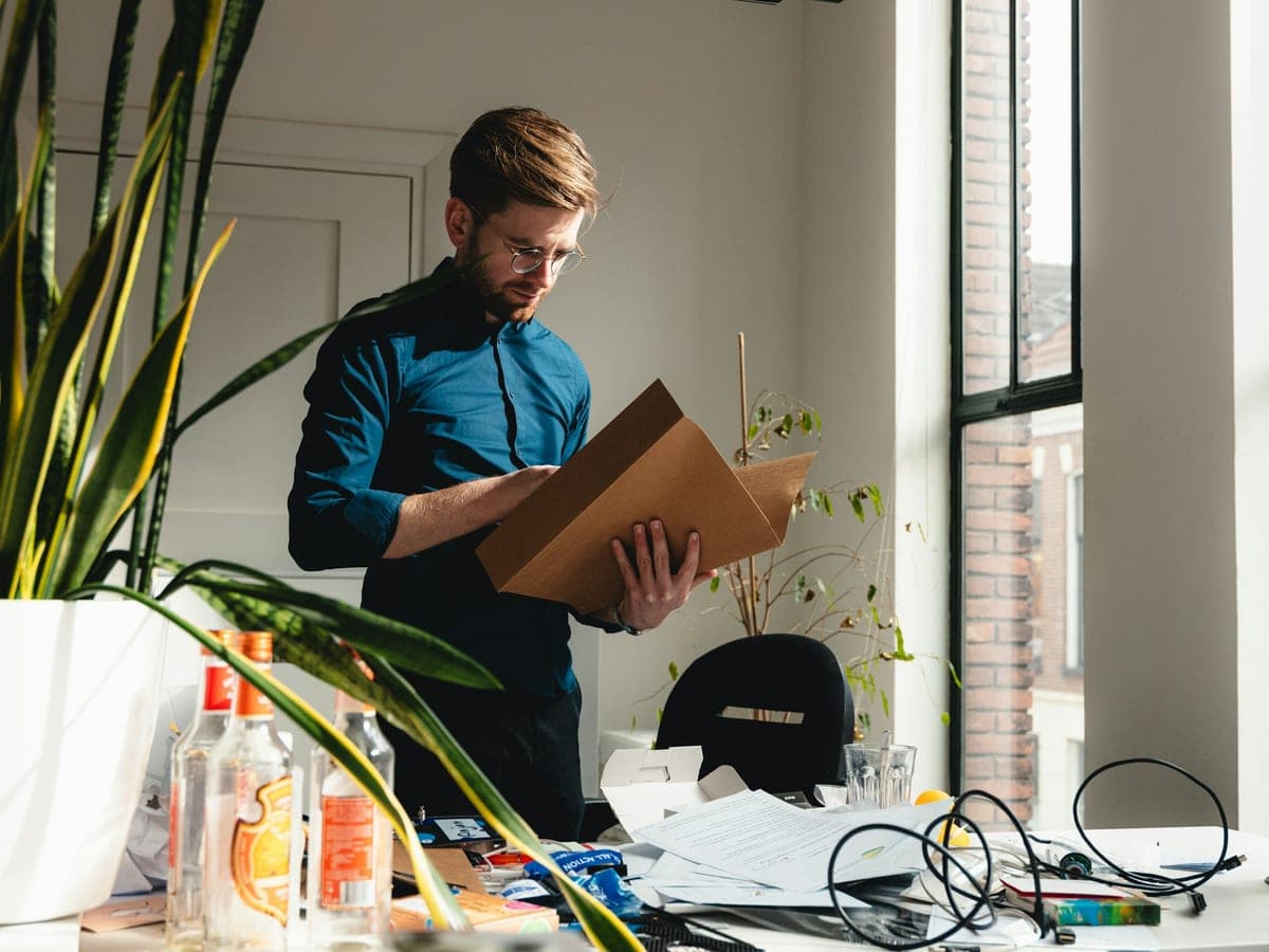 An employee carrying a box of files in an office